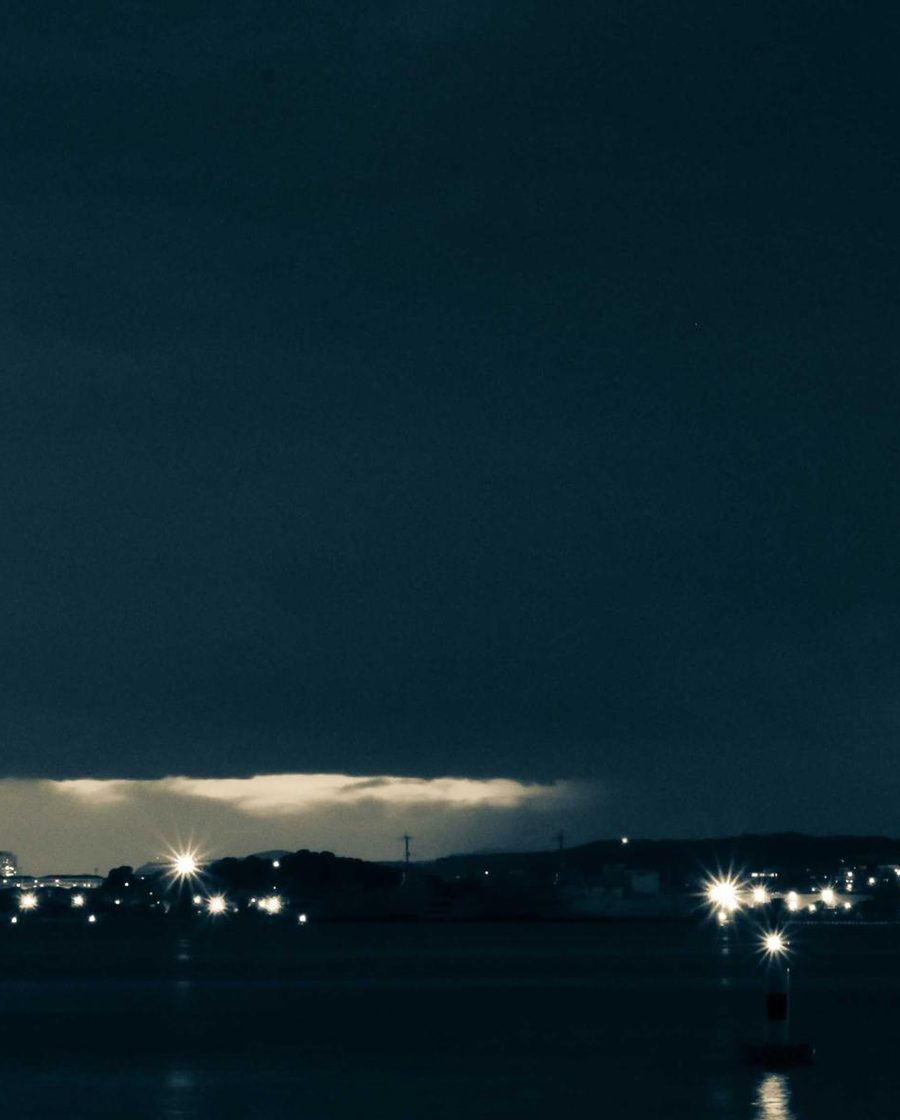 Atmospheric dusk over a waterfront skyline